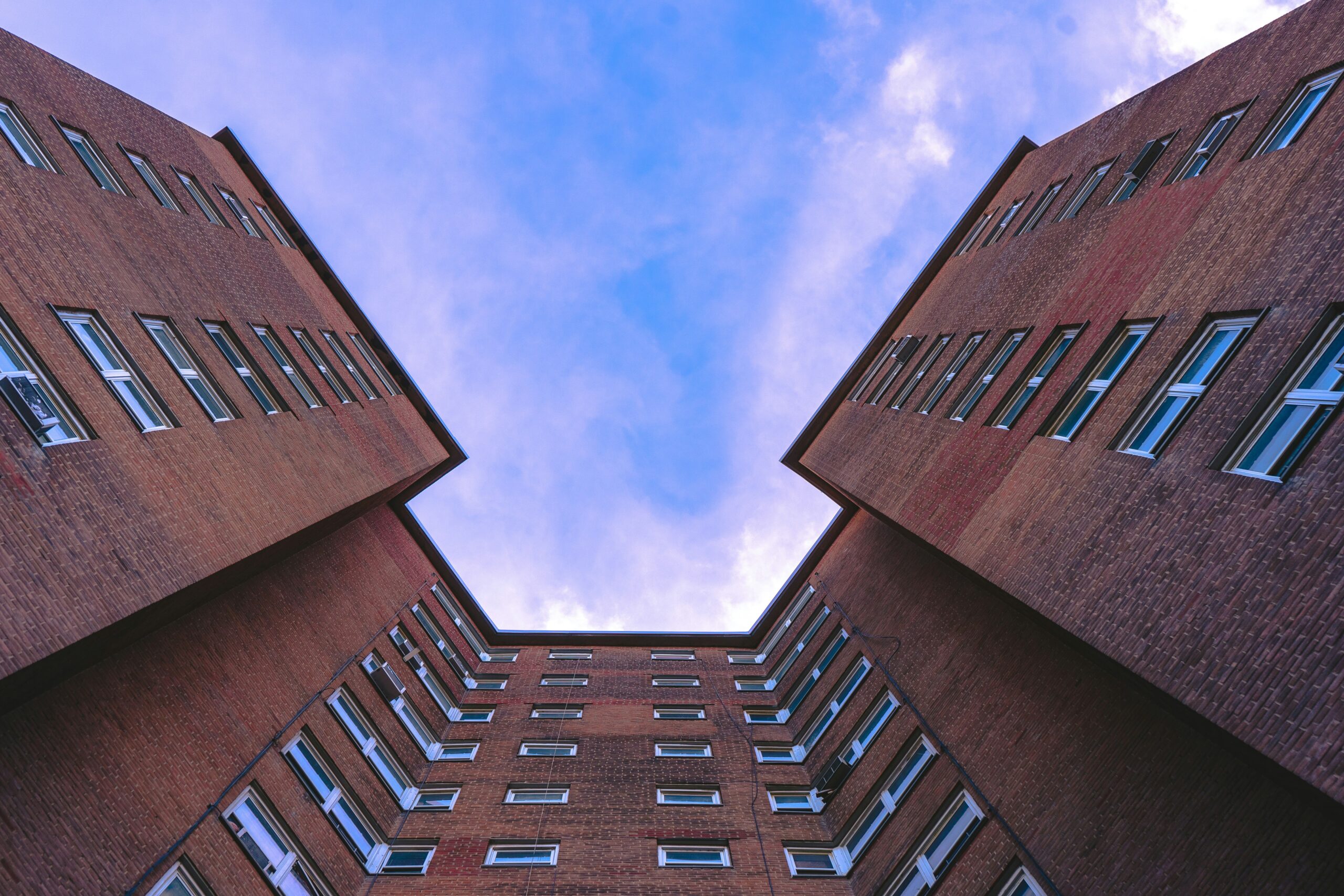 low-angle photography of brick high-rise during daytime.