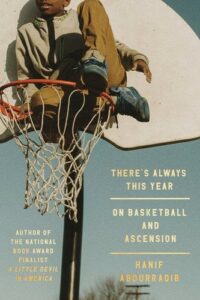 A boy is perched atop a basketball hoop in a sepia-toned photograph. Below him is written "There's Always This Year: On Basketball and Ascension" in golden lettering.