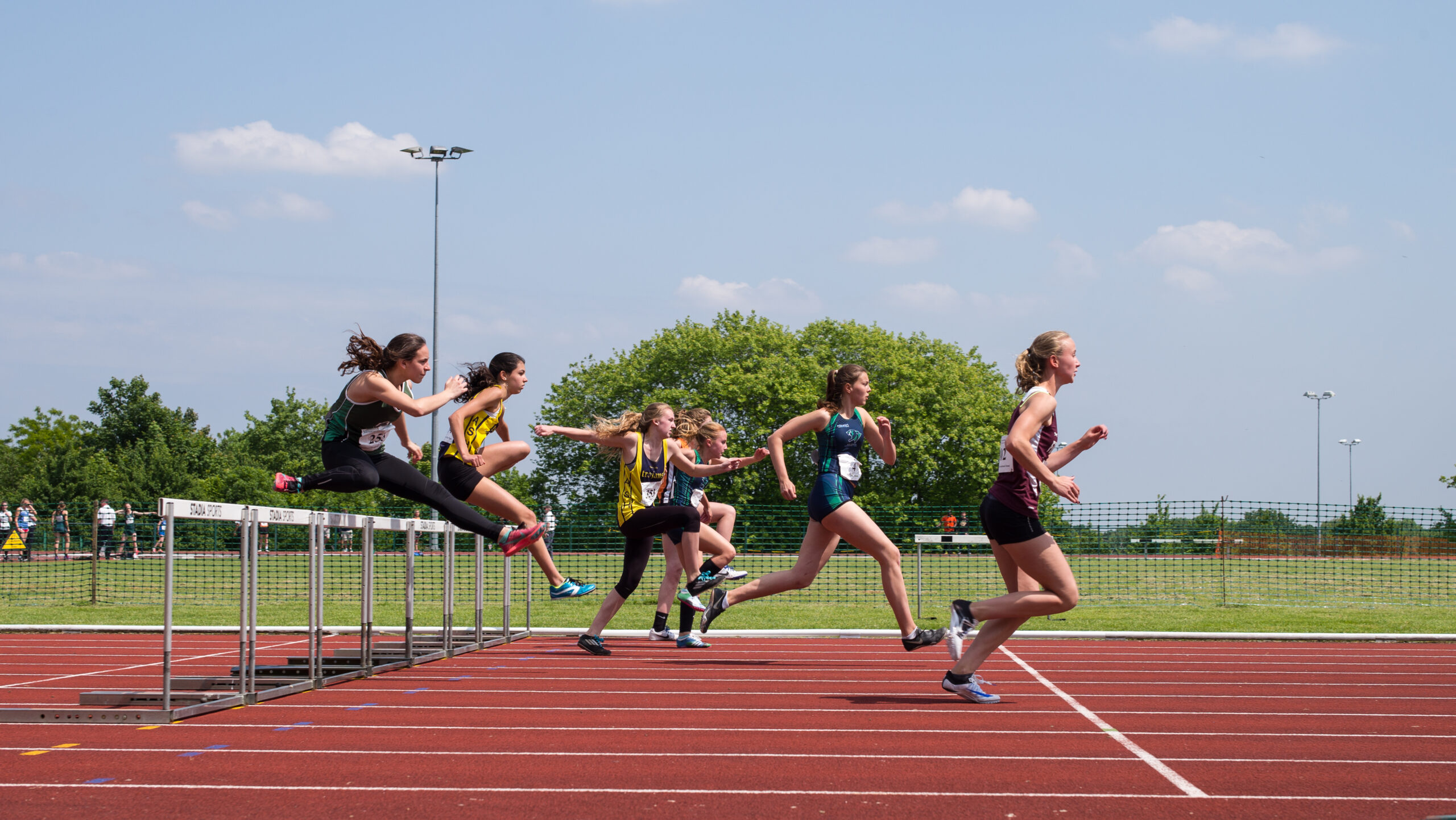 Women running hurdles