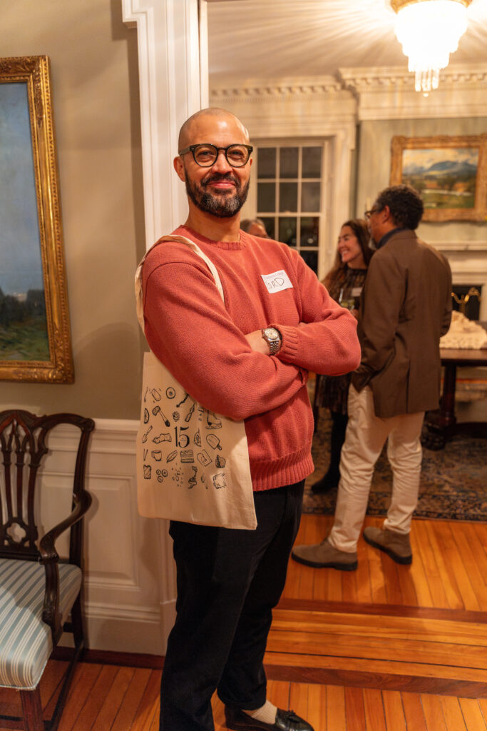 Jefferson smiling with a TC tote bag on his shoulder.