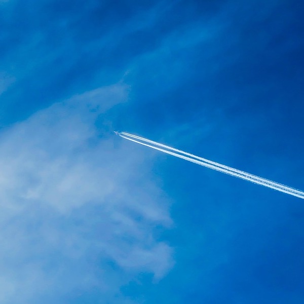 Contrail across blue sky
