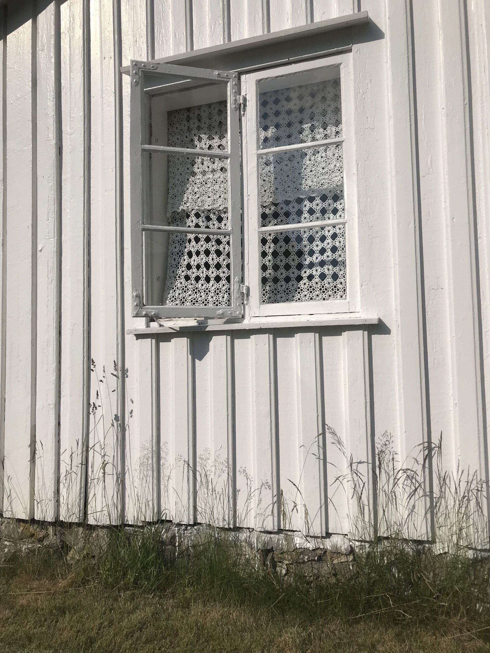 A window on the side of a white building in Temple, New Hampshire