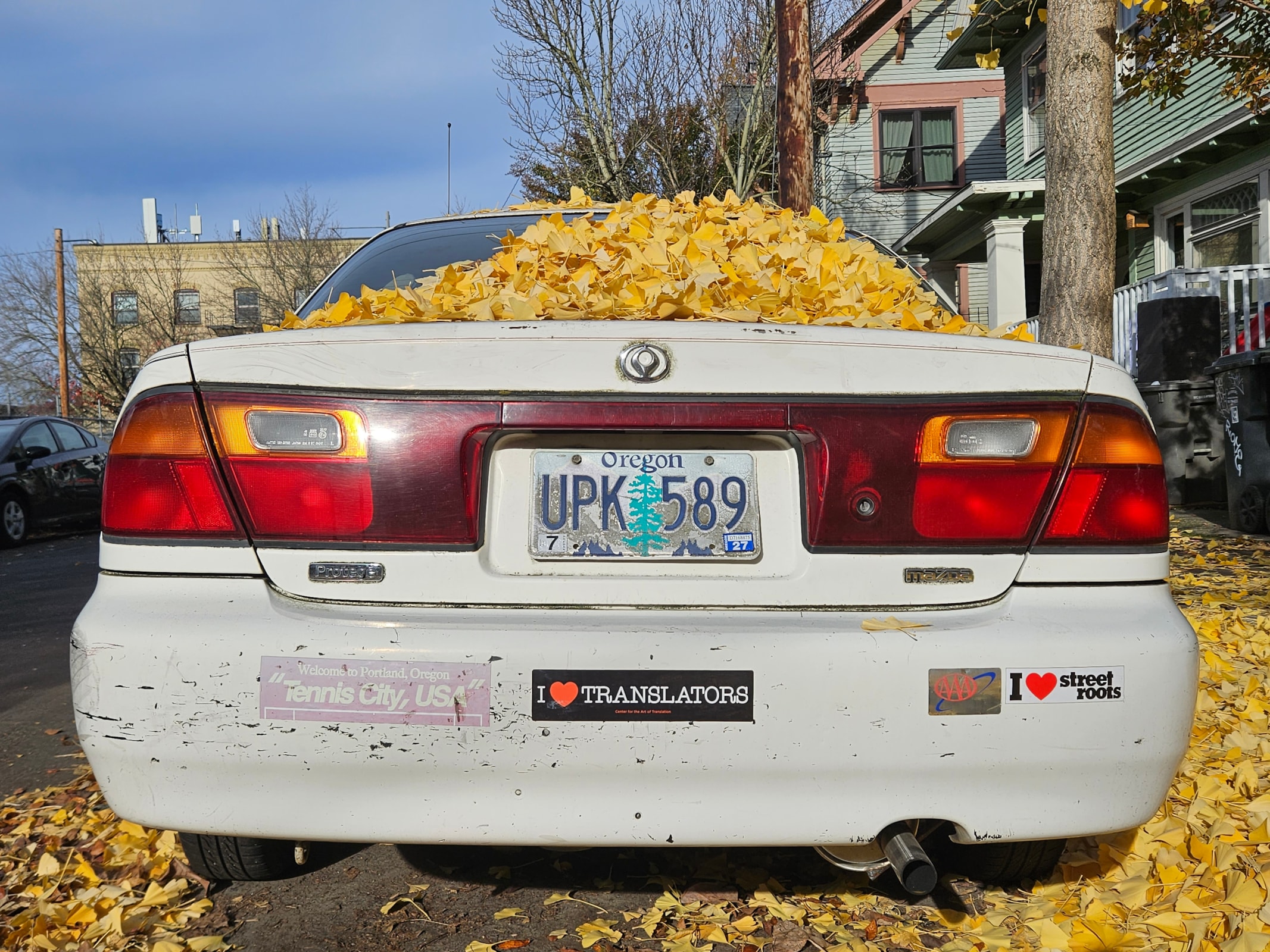 Image of a car with bumper sticker that reads "I heart translators"
